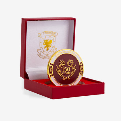 Gold and red commemorative coin with a logo in a red box on a white background - Celebrating 150 years of the Wales Football Association